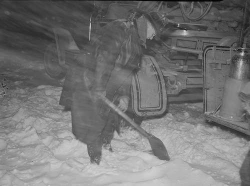 A firefighter tries to shovel out his truck during the storm. 