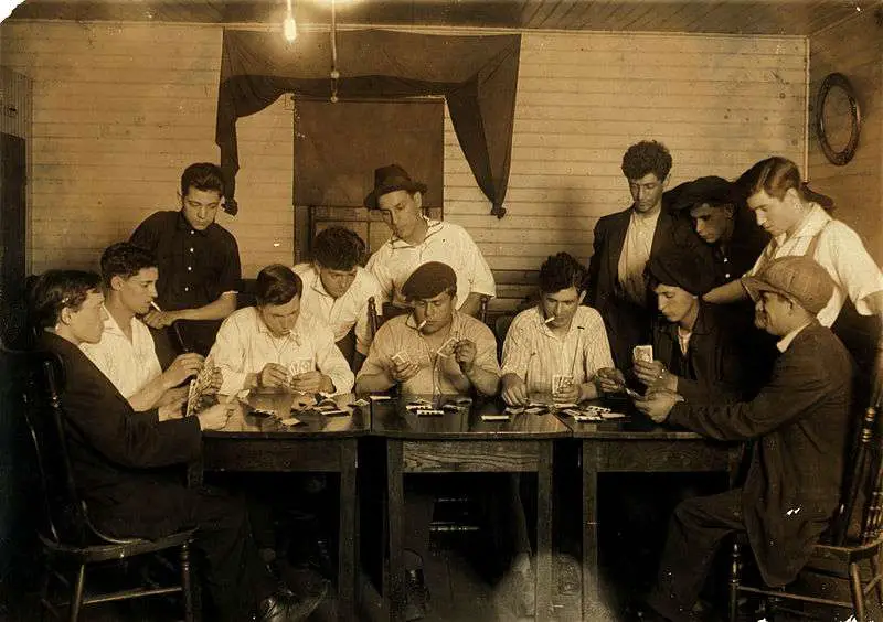 Evening recreation of the "Young Holy Ghosters" – Ages 15–25, average is 18 – all mill workers – all Portuguese. Whole House on George Street. Great need of leadership. Location: Fall River, Massachusetts. Photograph by Lewis Wickes Hine, 21 June 1916. Photo courtesy Library of Congress. 
