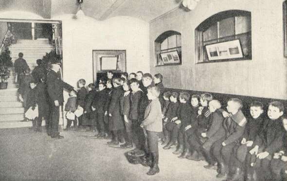 Children wait for the opening of the Dover Street Bathhouse, 1899.