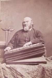 Alfred Little seated with his melodeon